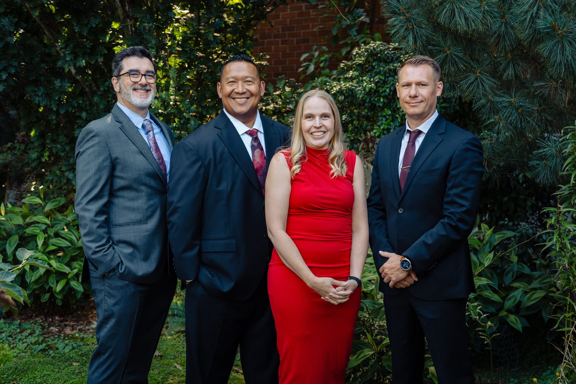 The Pumma Properties team standing together outdoors: Anthony Gladis, Bunsong Pumma, Emily Davis, and Justin Rood.